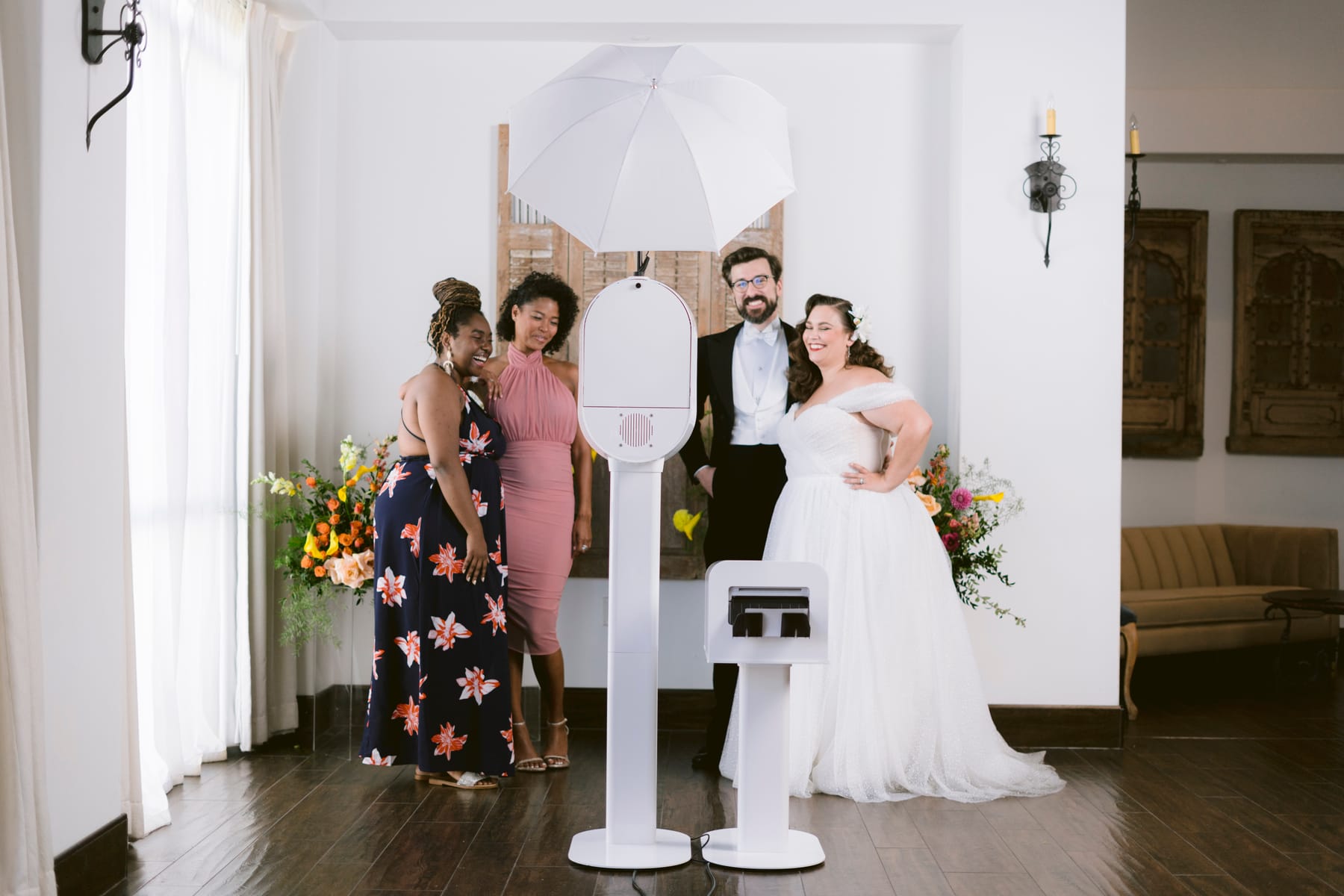 A wedding party posing around The Knot Photo Booth at a real event