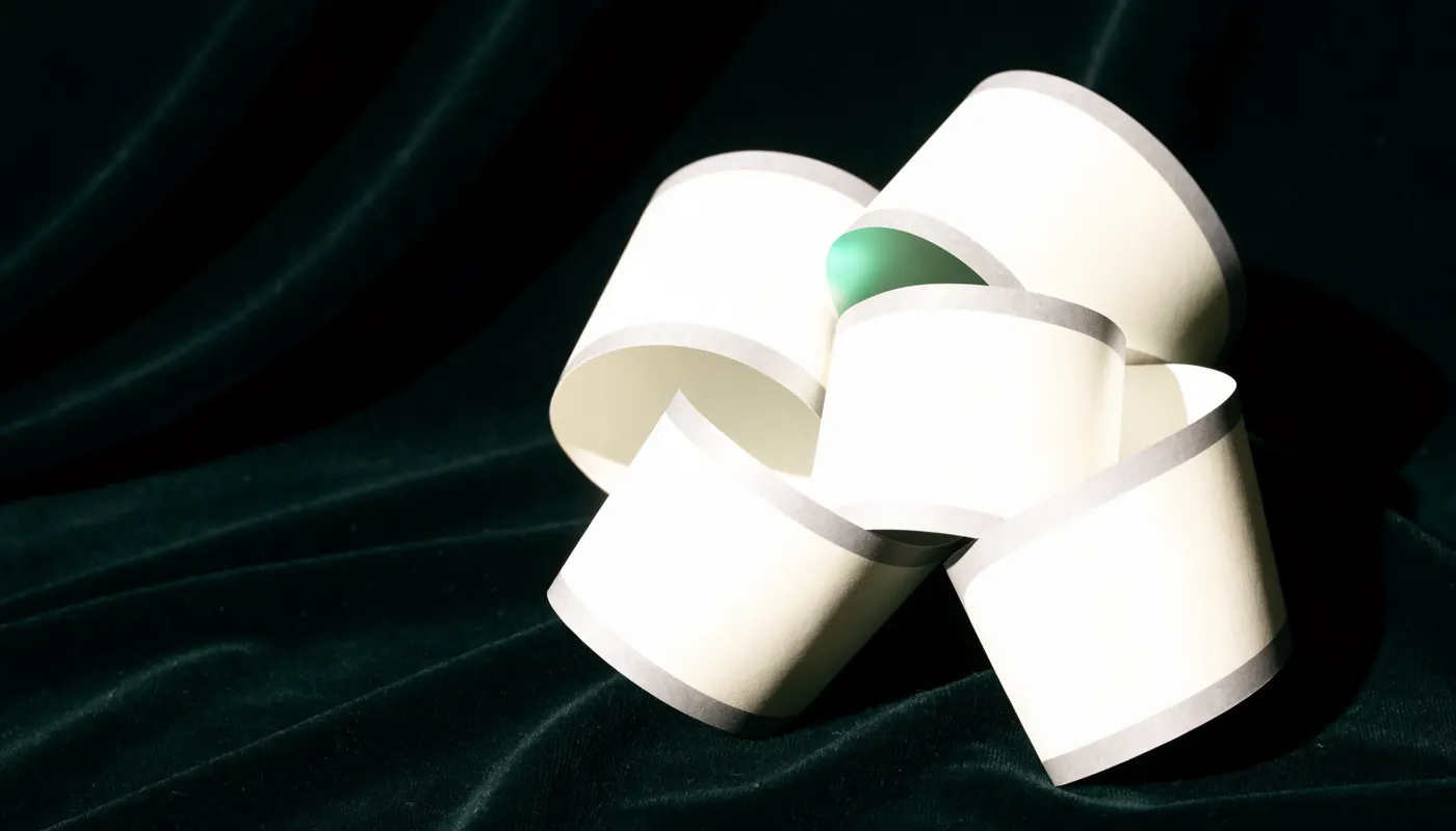 Blank photo booth paper formed into an abstract knot on evergreen velvet